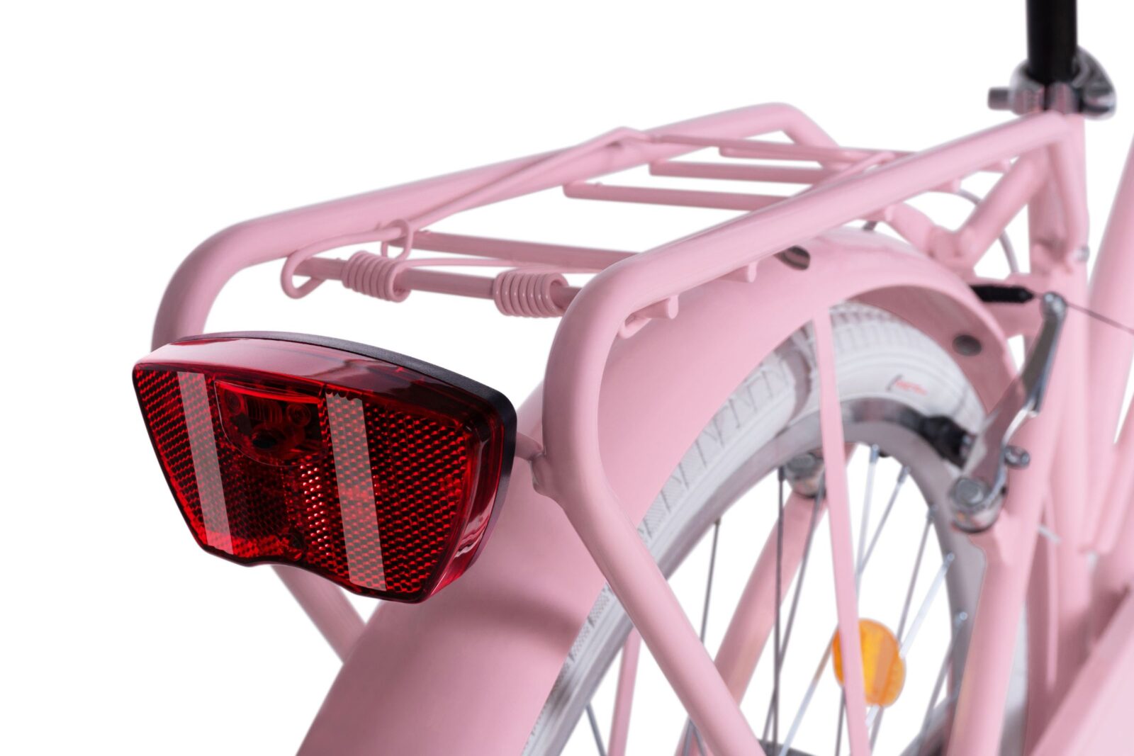 Tylny reflektor różowego roweru.
